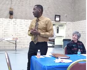 Derek Jordan mentoring students in a classroom