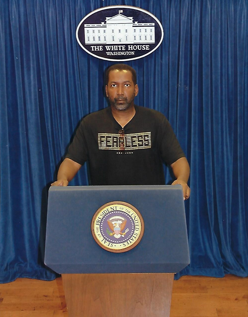 Derek Jordan speaking from a podium