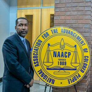 Derek Jordan Standing Next To NAACP Entrance